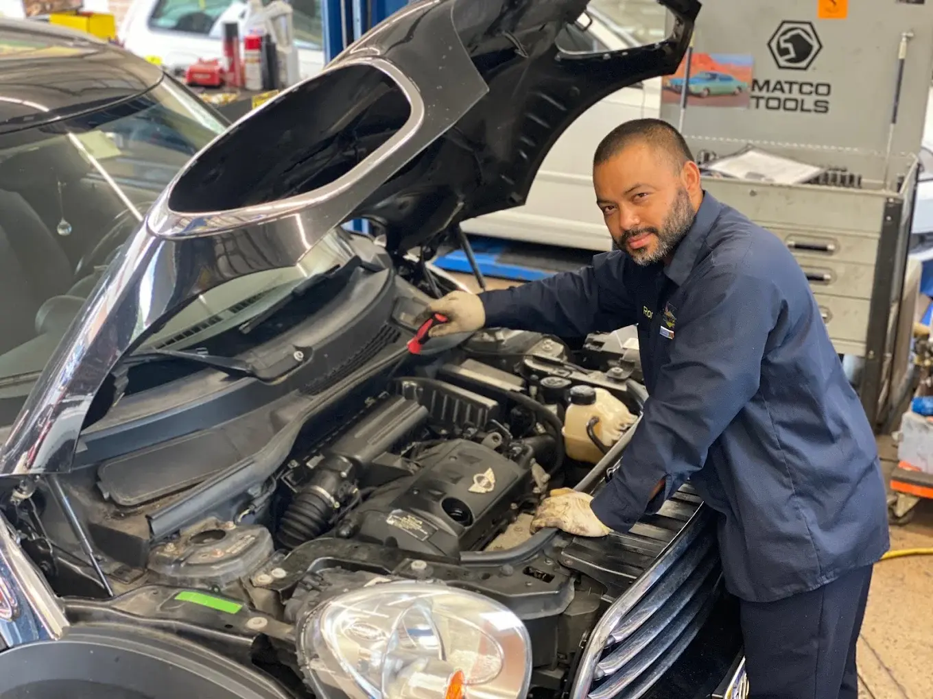 Technician checking an engine after the check engine light came on, at Rolling Road Sunoco in Springfield, VA