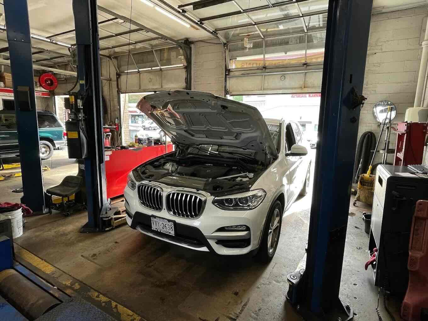 Technician checking brakes and tires to show what fails a Virginia state inspection at Rolling Road Sunoco in Springfield