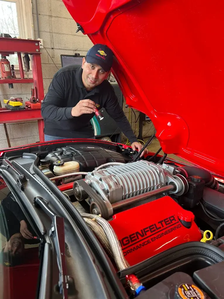 Technician checking a car at Rolling Road Sunoco, a Virginia inspection station in Springfield, before its inspection sticker expires